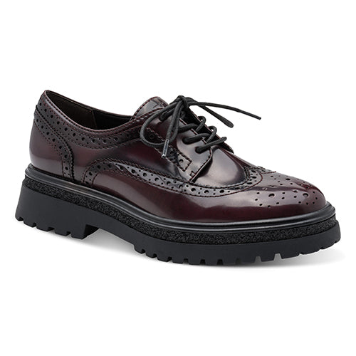 Burgundy brogues with black sole on a white background