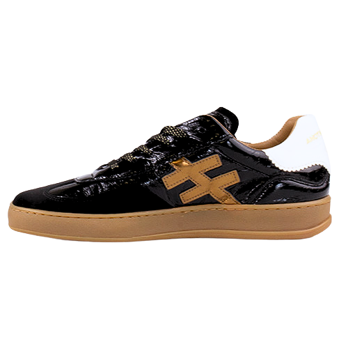 A low-top trainer with a glossy black patent leather upper, a tan faux-leather geometric side logo, a white heel tab, and a gum-colored sole.