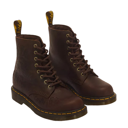 Brown floral embossed leather boots with 8 eyelets and yellow stitching on a plain background