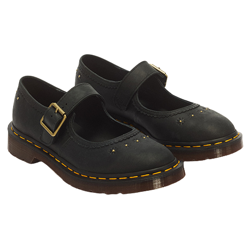 A pair of black leather Dr. Martens Mary Jane shoes with gold-tone buckle straps, decorative gold studs, and signature yellow stitching along the sole, shown on a plain white background.