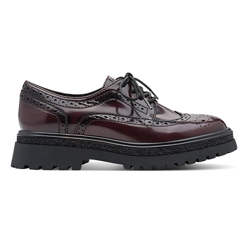 Burgundy brogues with black sole on a white background