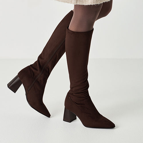 Brown knee-high boots on a white background