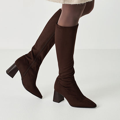 Brown knee-high boots on a white background