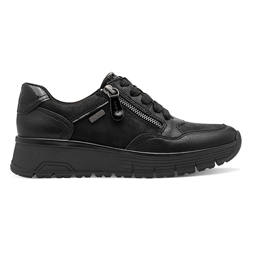 Black shoe with white sole on a light gray background