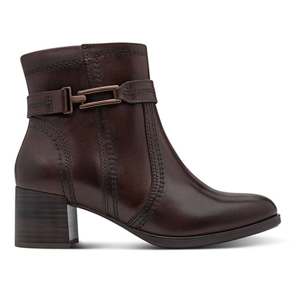 Brown ankle boot with a buckle on a white background