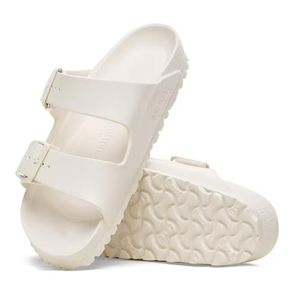 Pair of cream sandals on a white background