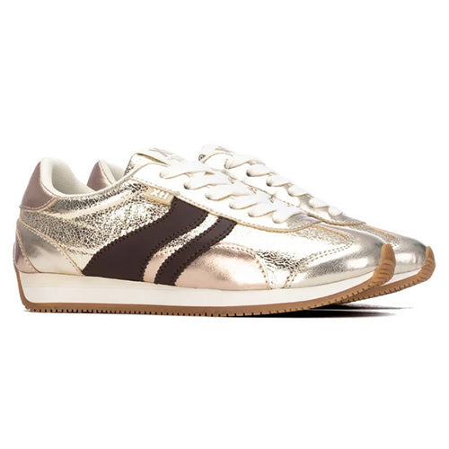 Metallic gold low-top sneakers with a dark brown side stripe, white laces, and a gum sole, shown against a plain white background.