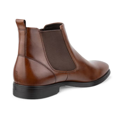A brown leather Chelsea boot with a black sole, shown from a three-quarters rear angle on a white background.
