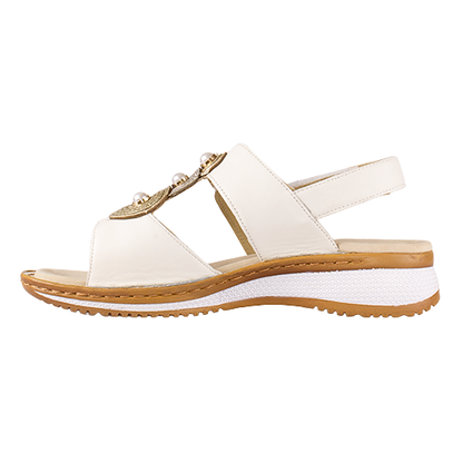 White sandal with a gold embellishment on a white background