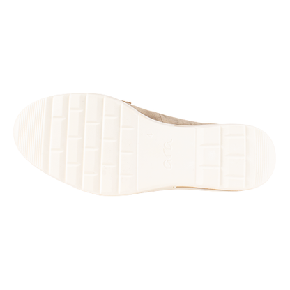 Sole of gold loafer shoe on a white background

