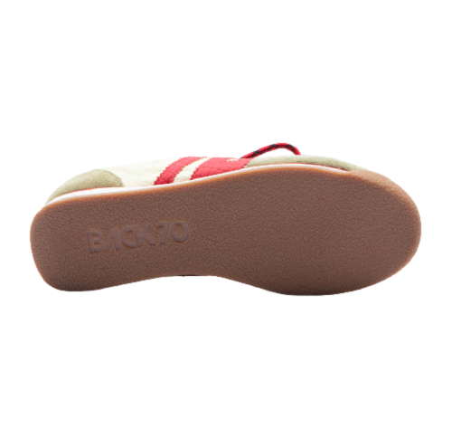 The outsole of a Back 70 slip-on shoe, showing a textured brown rubber sole with the brand name embossed, and the upper featuring cream and red panels.