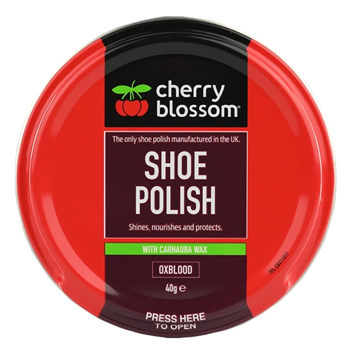 Red container of cherry blossom shoe polish on a white background
