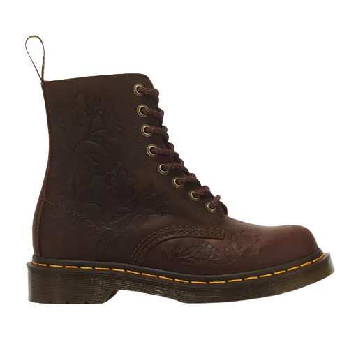 Single brown leather floral embossed boot with 8 eyelets and yellow stitching on sole on a plain background