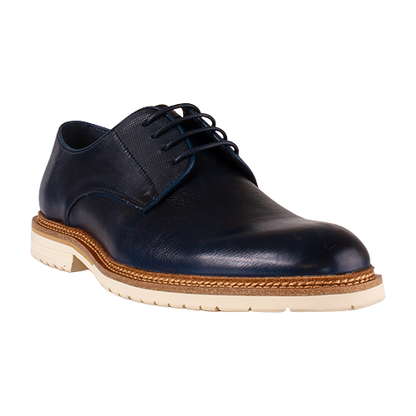 Navy leather shoe with a brown sole on a white background