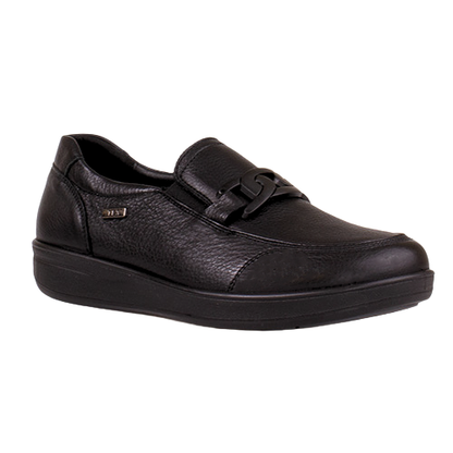 A black pebbled leather slip-on shoe with a decorative strap and buckle detail across the vamp, shown from a three-quarters angle on a plain white background.
