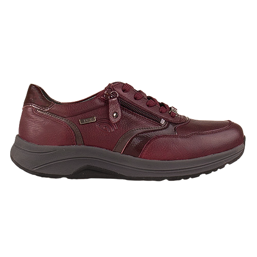 A burgundy leather walking shoe with a dark gray sole, featuring a zippered side entry, lace-up front, and a small metallic logo badge on the side.