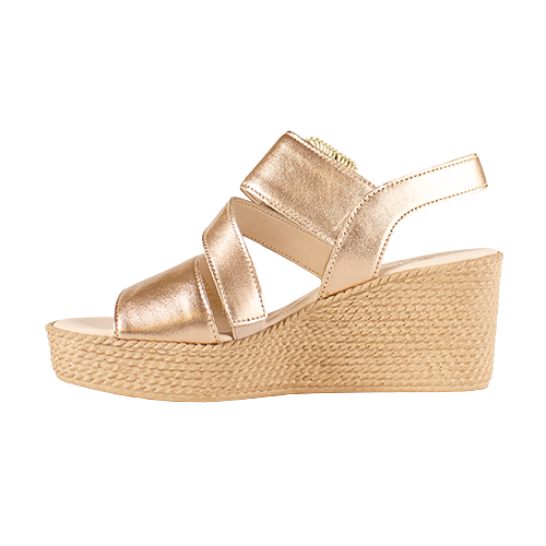 Gold wedge sandal with espadrille sole on a white background
