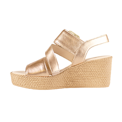 Gold wedge sandal with espadrille sole on a white background