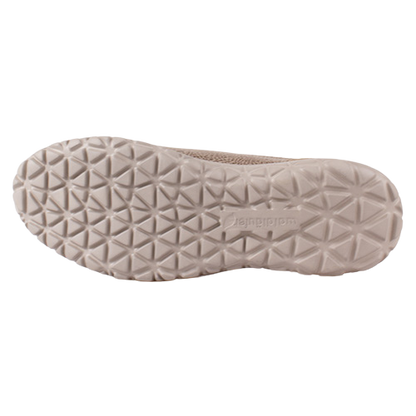 The outsole of a light beige slip-on shoe, showing a textured geometric tread pattern  on a plain background