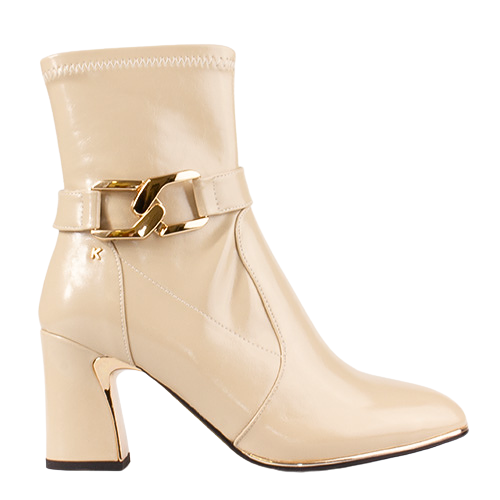 A beige patent leather ankle boot with a block heel and a gold-tone decorative buckle strap around the ankle, shown against a plain white background.