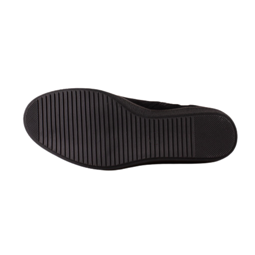 The black rubber outsole of a slip-on shoe, showing a ribbed tread pattern, photographed from a top-down view on a solid white background.
