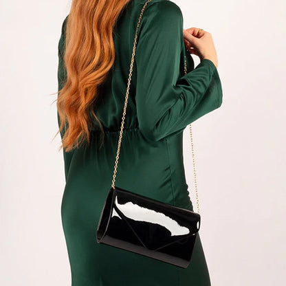 Person wearing Black Patent Clutch bag
