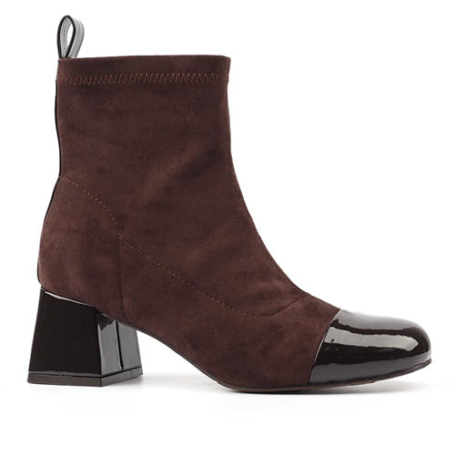 Brown suede ankle boot with black patent cap toe on a white background
