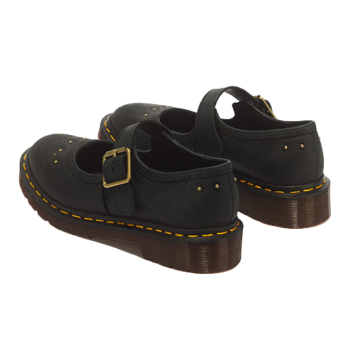 A pair of black leather Mary Jane shoes with gold-tone buckle straps, yellow welt stitching, and brown platform soles, shown from a three-quarters angle on a white background.