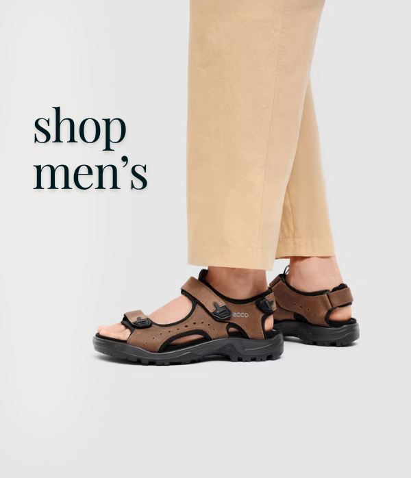 Brown sandals worn with beige pants on a light gray background, with text 'shop men's' on the left.
