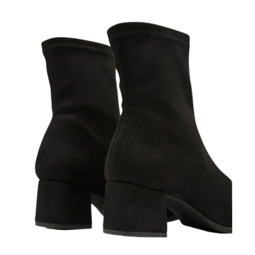 Black suede ankle boots on a white background