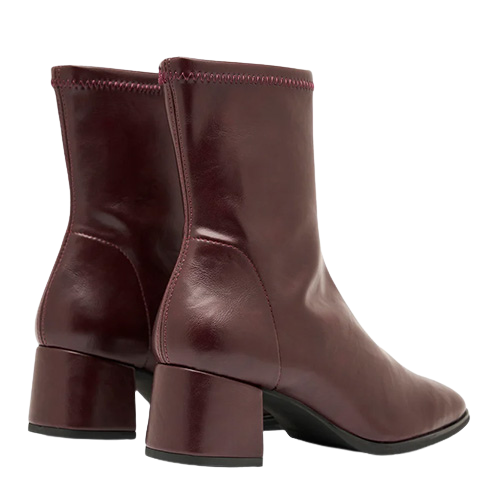 Pair of burgundy ankle boots on a white background