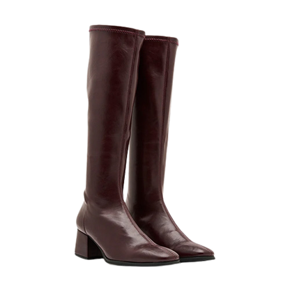pair of burgundy knee high boots on a white background