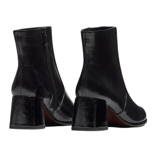 A pair of black leather ankle boots with block heels, shown from the back and side on a plain white background.