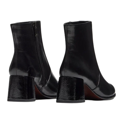 A pair of black leather ankle boots with block heels, shown from the back and side on a plain white background.