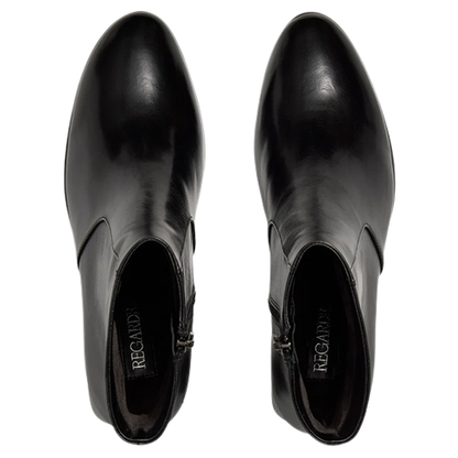 A pair of black leather ankle boots with a pointed toe, shown from a top-down view on a white background. The brand name &