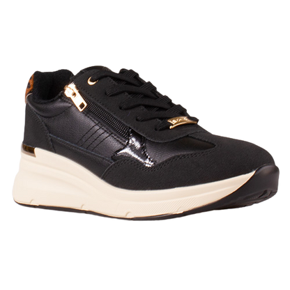 A black low-top sneaker with a thick cream-colored sole, black laces, a side zipper with gold-tone hardware, and gold logo detailing on the side and tongue.