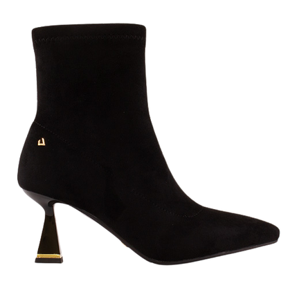 A black suede ankle boot with a pointed toe and a unique metallic gold geometric heel, shown from a side profile on a white background.