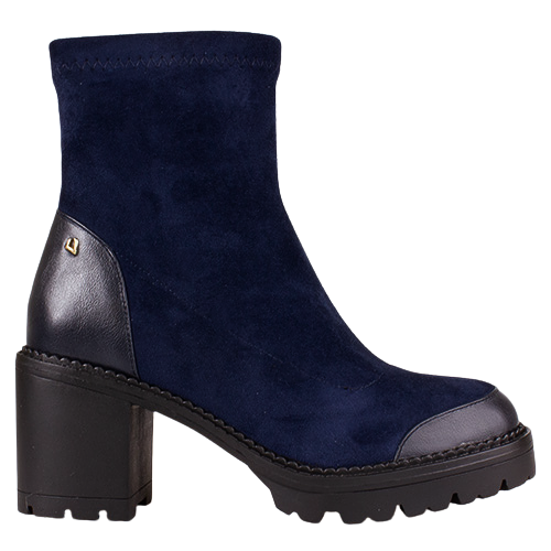 A navy blue suede ankle boot with black leather accents on the heel counter, toe cap, and sole, featuring a chunky black block heel and a small gold logo accent.