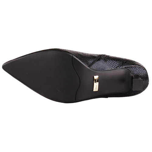 A black pointed-toe shoe shown from the sole view, featuring a textured black upper and a small gold metal brand plaque on the heel.