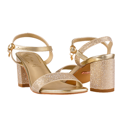 Gold high-heeled sandals with rhinestone embellishments on a white background