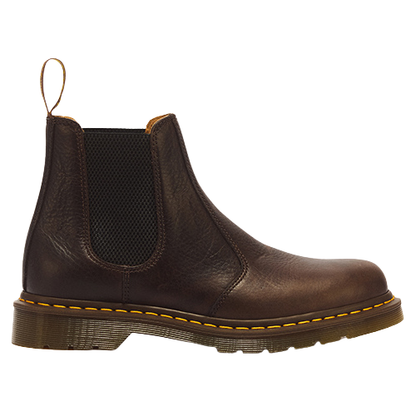 A dark brown leather Chelsea boot with a black elastic side panel and a yellow welt stitch along the sole, shown from a side profile on a white background.