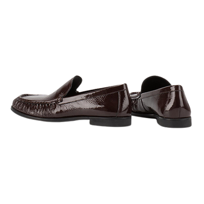 Pair of brown patent leather loafers on a white background