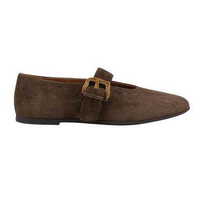A single dark brown suede flat shoe with a wide strap across the instep and a gold-tone buckle, shown in profile against a plain white background.