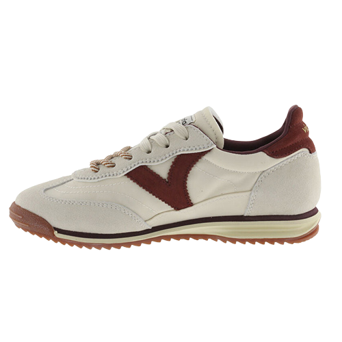 A low-top trainer shown in profile against a plain white background. The shoe features an off-white leather upper with a prominent dark burgundy V-shaped side stripe, matching burgundy heel tab, and brown textured rubber outsole.