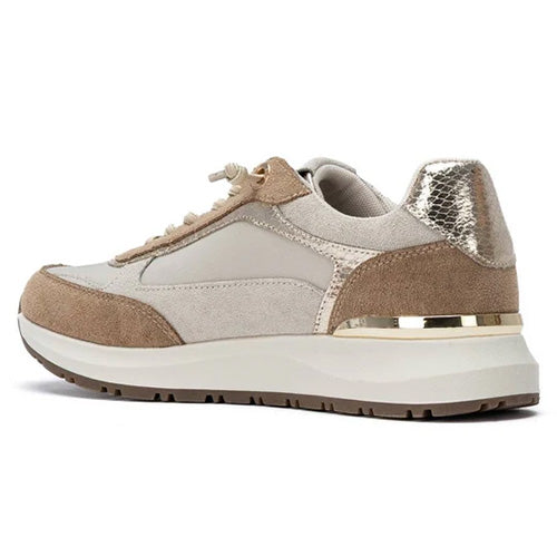 A low-top trainer in beige and taupe suede with a metallic silver snakeskin heel accent and a gold metallic band around the midsole, shown from a side profile on a white background.