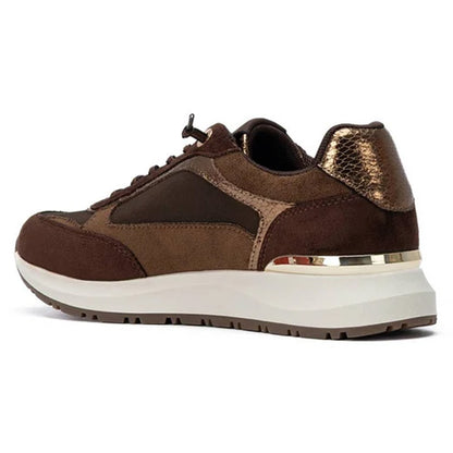 A brown and dark brown low-top trainer  with a metallic gold textured heel accent, a thick white midsole, and a thin gold metallic ring near the heel, shown from a side profile on a white background.